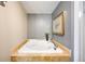Stylish bathroom featuring a deep soaking tub, tiled surround, and modern fixtures for relaxation at 2500 Walnut St # 201, Denver, CO 80205