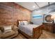 Comfortable bedroom with brick accent wall, wood floors, and modern decor create a relaxing space at 2500 Walnut St # 201, Denver, CO 80205