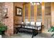 Unique dining room features exposed brick, decorative wood panels, modern lighting, and seating for six at 2500 Walnut St # 201, Denver, CO 80205