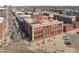 Brick building with signage and white accents in a dense urban location with street parking at 2500 Walnut St # 201, Denver, CO 80205