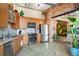 Modern kitchen with stainless steel appliances, light wood cabinets, and an open layout to the living area at 2500 Walnut St # 201, Denver, CO 80205