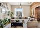 Bright living room with exposed brick, large windows, and stylish modern decor with neutral tones at 2500 Walnut St # 201, Denver, CO 80205