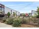 Outdoor seating area with wood fence, landscaping, and the Improper City building at 2500 Walnut St # 201, Denver, CO 80205