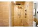 Modern shower with glass doors features a rainfall shower head, handheld wand, and built-in shelves at 2500 Walnut St # 201, Denver, CO 80205