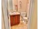 Cozy bathroom with wooden vanity, sink, toilet, and neutral decor at 9238 Viaggio Way, Highlands Ranch, CO 80126
