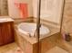 Elegant bathroom featuring a soaking tub and glass-enclosed shower with neutral tile finishes at 9238 Viaggio Way, Highlands Ranch, CO 80126