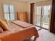 Bright bedroom with balcony access, warm tones, and comfortable furnishings, creating a relaxing retreat at 9238 Viaggio Way, Highlands Ranch, CO 80126
