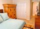 Bedroom with a large decorative wooden dresser and closet with sliding doors at 9238 Viaggio Way, Highlands Ranch, CO 80126