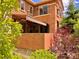 Exterior view of a home with a covered patio, balcony, and lush landscaping at 9238 Viaggio Way, Highlands Ranch, CO 80126