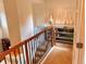 Hallway landing with wooden banister and ornamental iron spindles leads to cozy room with light-filled windows at 9238 Viaggio Way, Highlands Ranch, CO 80126
