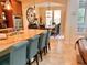 Well-appointed kitchen with a large island and seating, seamless flow to dining area, and modern stainless appliances at 9238 Viaggio Way, Highlands Ranch, CO 80126