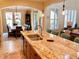 Open kitchen with large island, granite countertops, stainless steel sink, and an adjacent dining area at 9238 Viaggio Way, Highlands Ranch, CO 80126