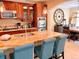 Modern kitchen with granite countertops, stainless steel appliances, barstool seating, and dining area at 9238 Viaggio Way, Highlands Ranch, CO 80126