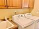 Bright laundry room with sink, counter, washer, and dryer machines at 9238 Viaggio Way, Highlands Ranch, CO 80126