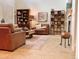 Comfortable living room featuring a cozy seating arrangement and a fireplace, bookshelves with stylish decor at 9238 Viaggio Way, Highlands Ranch, CO 80126