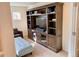 Media room with a large built-in shelving unit and plush seating, perfect for movie nights at 9238 Viaggio Way, Highlands Ranch, CO 80126