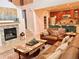 Inviting living room with a cozy fireplace, comfortable seating, open to kitchen, and stylish decor at 9238 Viaggio Way, Highlands Ranch, CO 80126