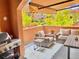 Outdoor patio with comfortable seating, a built-in grill, and a retractable awning for shade at 9238 Viaggio Way, Highlands Ranch, CO 80126