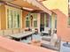 Covered outdoor patio features comfortable seating, a table, and access to the house through sliding glass doors at 9238 Viaggio Way, Highlands Ranch, CO 80126