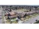 A large brick school building with a playground and a sports field at 110 Forest St, Denver, CO 80220