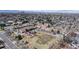 Aerial view of a school featuring playgrounds, sports fields, and the surrounding community at 110 Forest St, Denver, CO 80220