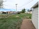 Spacious backyard featuring a chain-link fence, lawn, and a glimpse of neighboring properties at 437 S Fetzer St, Byers, CO 80103