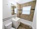 This bathroom features a toilet, vanity, mirror, and a tiled bathtub and shower combination at 437 S Fetzer St, Byers, CO 80103