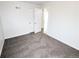 A carpeted bedroom showcasing access to another room, closet storage, and neutral color scheme at 437 S Fetzer St, Byers, CO 80103