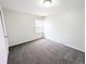 This is a simple bedroom featuring gray carpet, white walls, and a window for natural light at 437 S Fetzer St, Byers, CO 80103