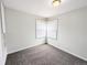 Small bedroom features neutral carpet, a window with blinds, and good natural lighting at 437 S Fetzer St, Byers, CO 80103
