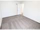Bright bedroom offers neutral carpet, white walls, and a doorway visible to another room at 437 S Fetzer St, Byers, CO 80103