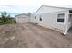 Home exterior and detached garage with a long gravel driveway at 437 S Fetzer St, Byers, CO 80103