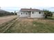 Charming single-story home with neutral siding, well-lit windows, and an adjacent gravel drive at 437 S Fetzer St, Byers, CO 80103