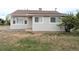 A charming single-story home featuring a well-kept lawn, tidy siding, and traditional windows for a welcoming curb appeal at 437 S Fetzer St, Byers, CO 80103