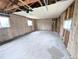 Unfinished garage with exposed insulation, concrete floor, and natural light from multiple windows at 437 S Fetzer St, Byers, CO 80103