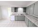 The updated kitchen features tile flooring, functional appliances, and plenty of storage cabinets for all your cooking needs at 437 S Fetzer St, Byers, CO 80103