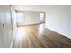 Spacious living room with beautiful hardwood flooring and natural light streaming in through large windows at 437 S Fetzer St, Byers, CO 80103