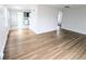 Bright living room featuring gleaming hardwood floors and an open layout leading to the kitchen at 437 S Fetzer St, Byers, CO 80103