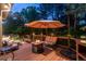 Cozy back deck with a fire pit, cushioned seating, and lush garden surroundings at 5063 E Otero Cir, Centennial, CO 80122