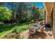 Outdoor brick patio with a dining table, comfortable seating, and vibrant flowerbeds at 5063 E Otero Cir, Centennial, CO 80122