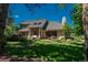 A spacious backyard features a lush lawn, mature trees, and patio perfect for outdoor living at 5063 E Otero Cir, Centennial, CO 80122