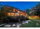 Large backyard featuring a stone patio, garden, and manicured lawn at 5063 E Otero Cir, Centennial, CO 80122