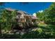 An ample backyard is surrounded by verdant foliage, stone paths, and lots of shade at 5063 E Otero Cir, Centennial, CO 80122