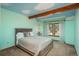 Charming bedroom with whimsical cloud ceiling, exposed beams, and a large window at 5063 E Otero Cir, Centennial, CO 80122