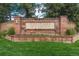 A stately brick sign marks the entrance to Heritage Greens with manicured landscaping at 5063 E Otero Cir, Centennial, CO 80122
