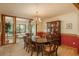 Formal dining room featuring a classic chandelier, elegant china cabinet, and access to the sunroom at 5063 E Otero Cir, Centennial, CO 80122