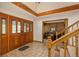 Grand foyer featuring a staircase, and an office with wood paneling at 5063 E Otero Cir, Centennial, CO 80122