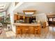 Unique kitchen with a breakfast bar, wooden stools, and an open design that connects to the living area at 5063 E Otero Cir, Centennial, CO 80122