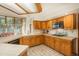Well-lit kitchen boasting stainless steel appliances, wooden cabinets, and a functional layout at 5063 E Otero Cir, Centennial, CO 80122