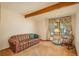 Living room with striped sofa, rocking chair, and natural light from a large window at 5063 E Otero Cir, Centennial, CO 80122
